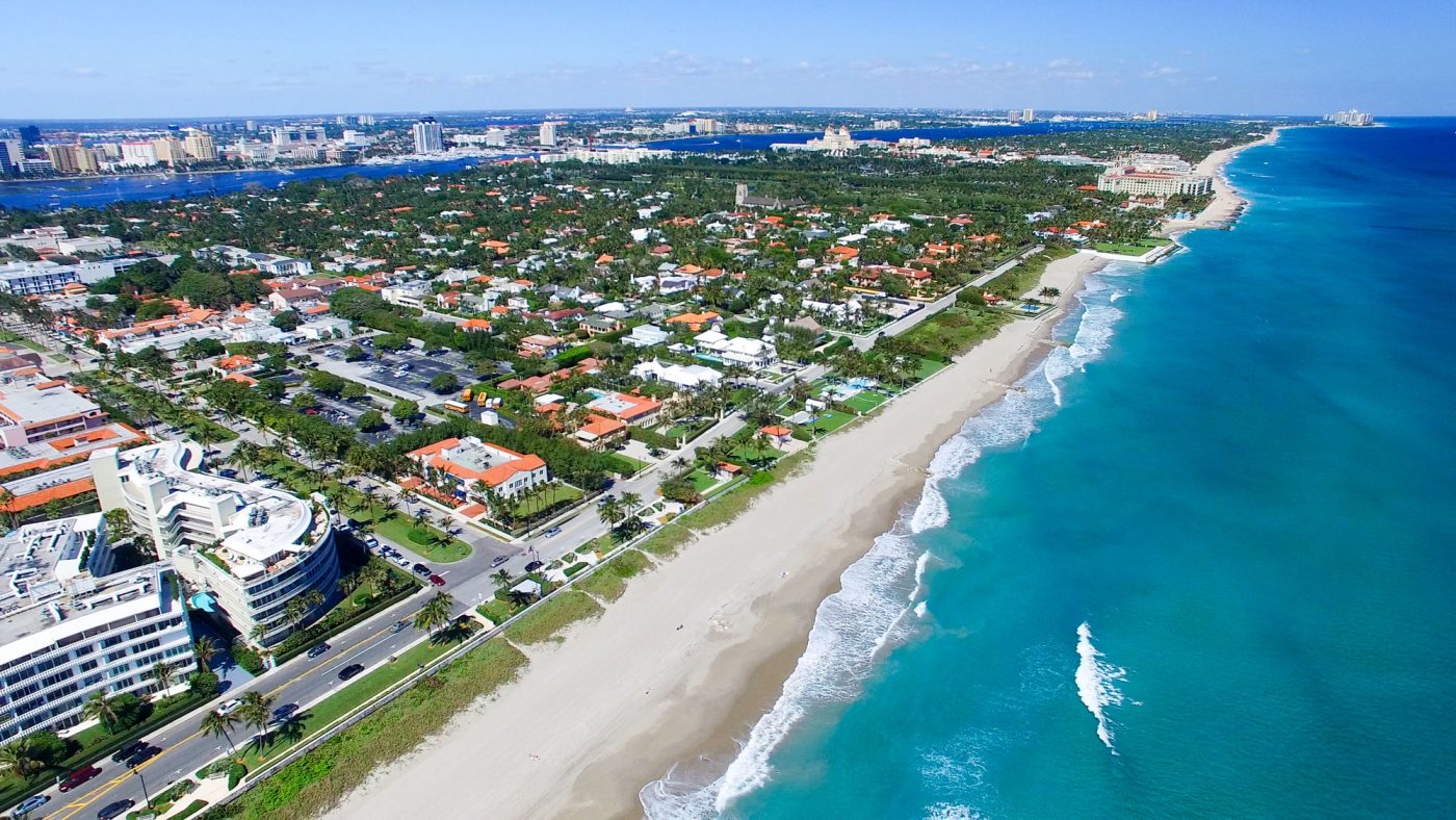 aerial view of Palm Bay city with bright turquoise waves breaking on the beach on the right